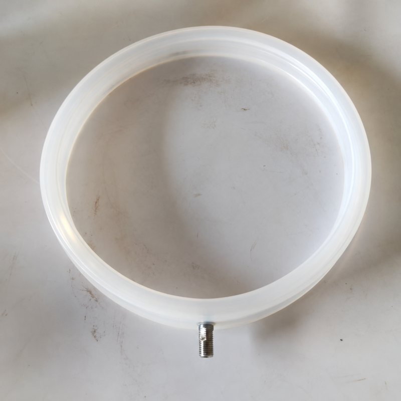 Top view of a translucent white IKSONIC inflatable seal ring and threaded air fitting.