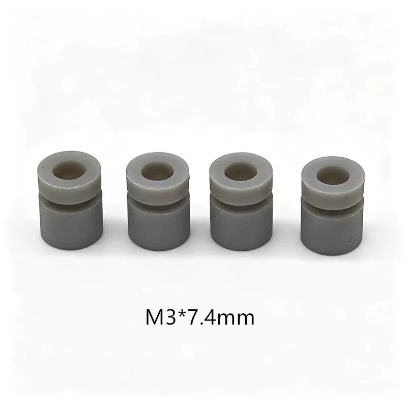 iksonic-m3-7-4mm-grey-damper-four-piece-view Four grey cylindrical damping parts with visible grooves and central holes, supplied by IKSONIC in China.