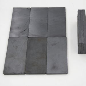 Dark rectangular IKSONIC magnetic ceramic liner tiles arranged flat with visible surface markings.