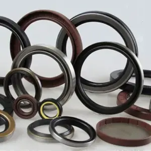 Assorted IKSONIC rotary oil seals arranged upright and flat, showing metal outer cases and black and brown sealing elements.