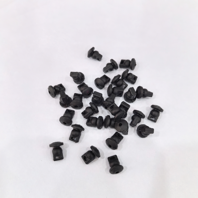 iksonic-mini-5-pro-gimbal-damping-pieces-supplier-01 Black gimbal damping pieces for Mini 5 Pro in a scattered grouping, showing their flanges and mounting openings.