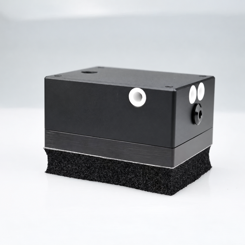 IKSONIC compact foam vacuum gripper body with pneumatic ports and a foam contact pad.