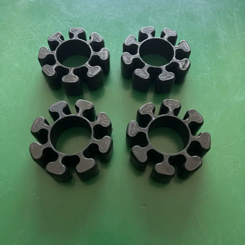 iksonic-mt85-mt100-grinder-coupling-inserts-china-supplier Four black lobed grinder coupling insert examples on a green surface, IKSONIC China supplier