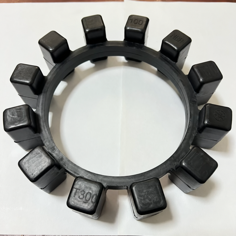 Close view of an IKSONIC NBR coupling ring showing its twelve drive blocks and molded material and model markings.