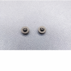 IKSONIC supplier photo showing two piezo dispensing valve seals with central bores on a textured surface.
