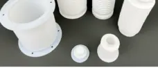 PTFE bellows viewed from above, showing open bores, corrugated walls and flanged ends; supplied by IKSONIC in China.