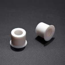 Two white PTFE flanged bushings upright and on their side, showing bore and flange, IKSONIC wholesale supply