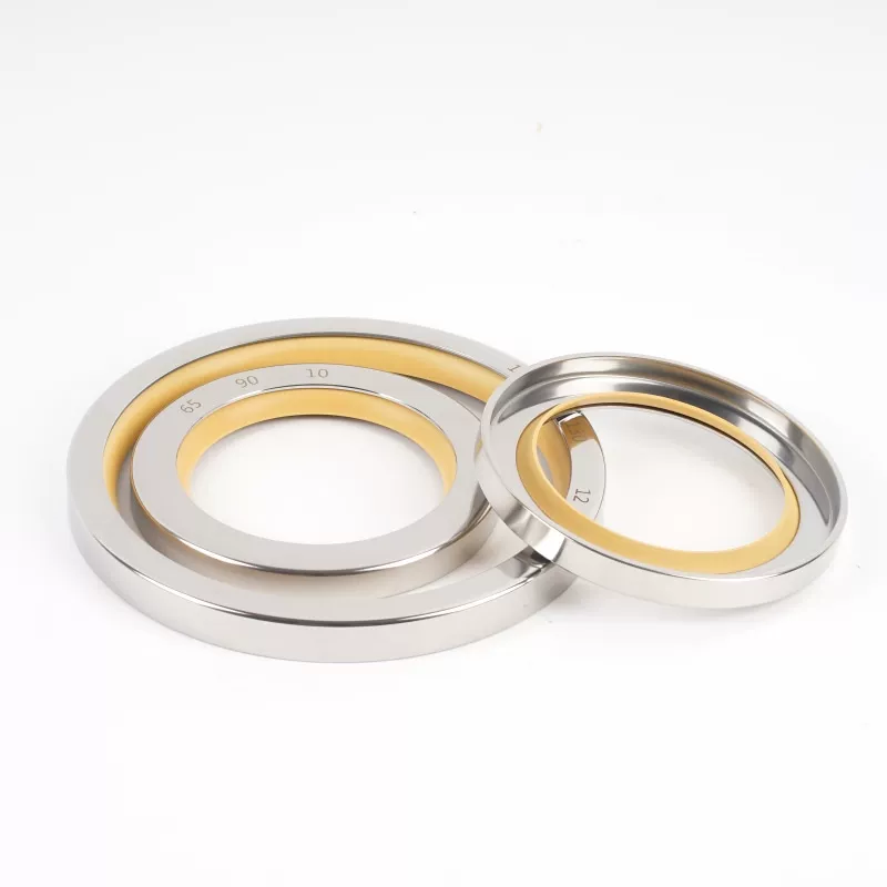 iksonic-ptfe-stainless-steel-oil-seals-china-supplier Stainless steel oil seals with yellow PTFE lips on a white background, supplied by IKSONIC in China