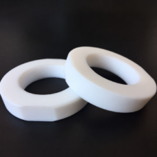 Two overlapping white PTFE threaded hex nuts on a dark background for IKSONIC wholesale supply