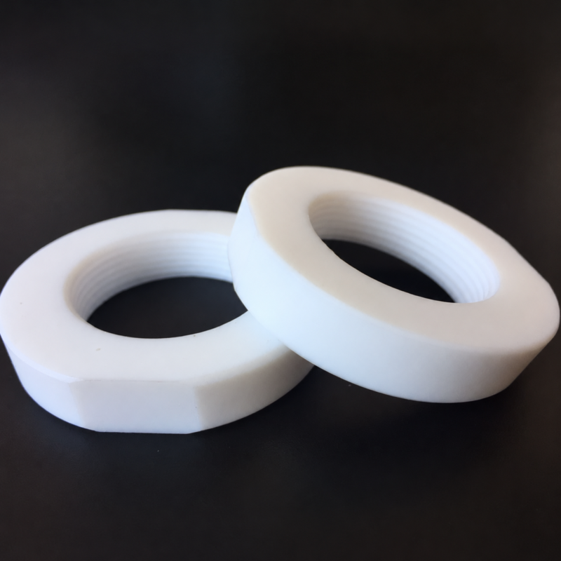 Two overlapping white PTFE threaded hex nuts on a dark background for IKSONIC wholesale supply