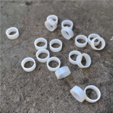 IKSONIC PTFE valve stem seal rings shown as an application example on a gray surface.