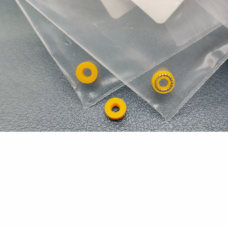 Three yellow ring seals beside clear packaging, with one spring-facing ring and two reverse-face views.