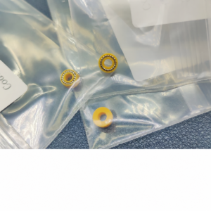 Three IKSONIC yellow pump plunger seals on clear packaging, with two metal spring inserts visible and one reverse-face view.