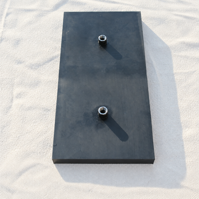 Rectangular black IKSONIC rubber airbag pad with two air inlets on a light woven background.