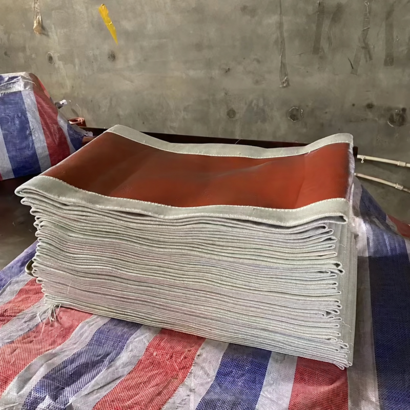 Folded red-coated fabric expansion joint skins showing layered white edges.