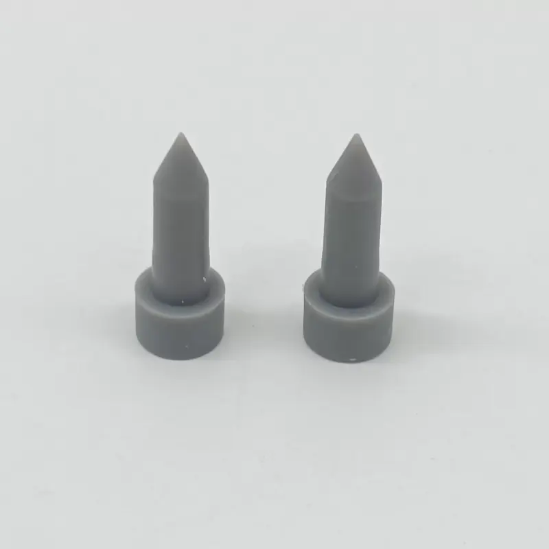 Two upright grey silicone plugs showing tapered stems and round bases, IKSONIC supplier view