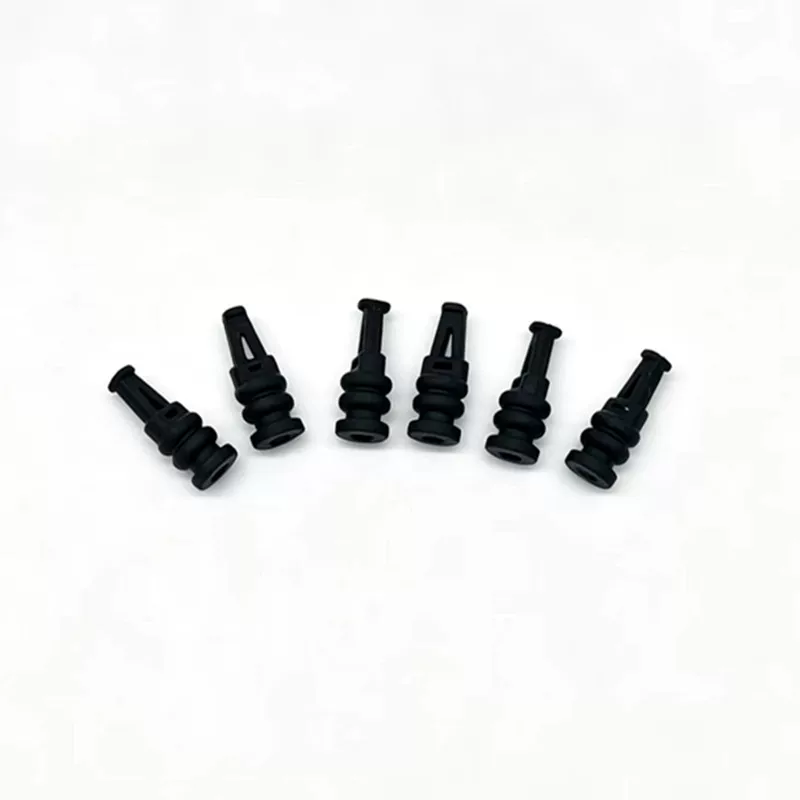 Black silicone flight-controller damping parts arranged in a fan, showing pointed retaining sections and grooved bases, supplied by IKSONIC.