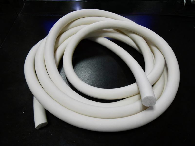 White silicone sponge round cord coiled with two visible cut ends, supplied by IKSONIC, China.