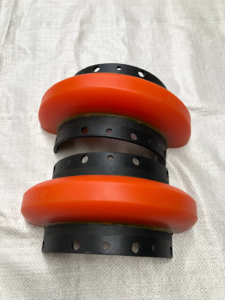 Two IKSONIC orange split coupling halves showing black mounting bands, bolt holes and molded 40 markings.