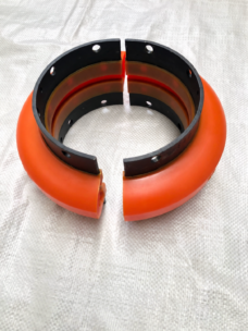 IKSONIC orange split coupling element with black mounting bands, shown as two matching halves.