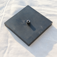 Angled view of a square black inflatable rubber airbag pad with one air inlet.