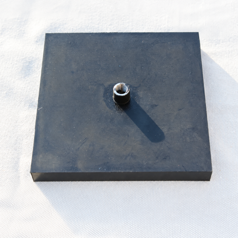 iksonic-square-inflatable-airbag-threaded-inlet Square black IKSONIC inflatable rubber airbag pad with one central air inlet on a light woven background.