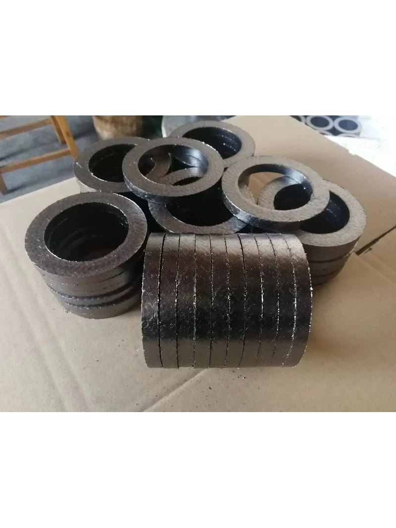 Graphite packing rings stacked on their edges in front of additional ring stacks.