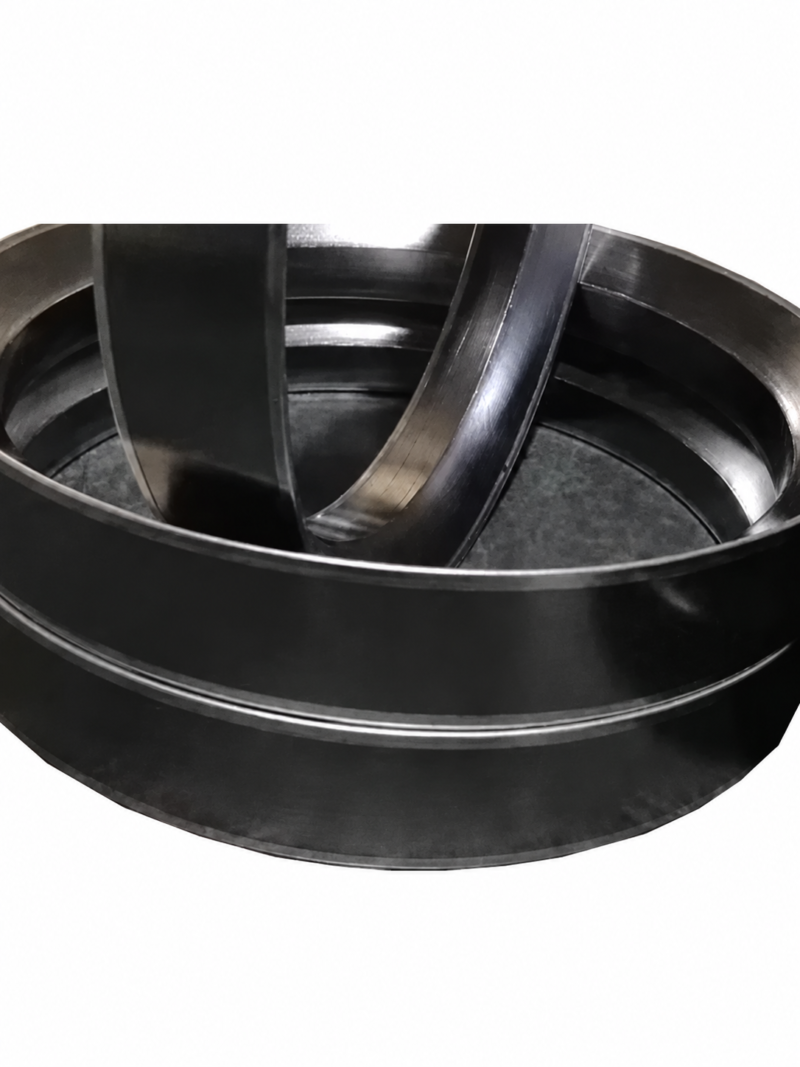 Close-up of overlapping graphite self-sealing rings from an IKSONIC supplier, with the original cropped edges retained.