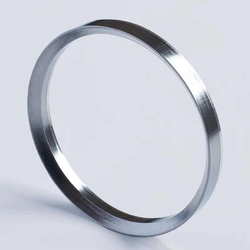 iksonic-supplier-jt-rg730-graphite-self-sealing-ring-single Single beveled graphite self-sealing ring shown at an angle on a light background.