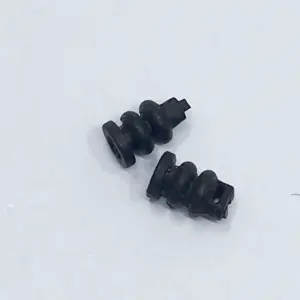 Close-up of two black IKSONIC camera gimbal dampers showing the ribbed profile and attachment openings.