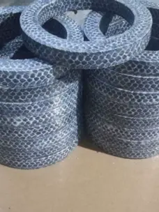 Stacks of graphite packing rings with a visible mesh-pattern surface.