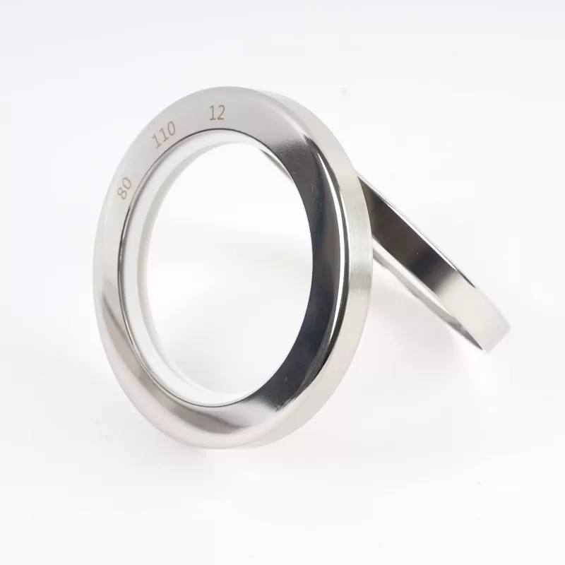 Stainless steel PTFE oil seals in an angled view with white sealing material and original ring markings; supplied by IKSONIC in China