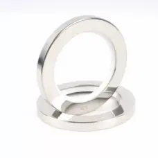 Stainless steel PTFE oil seals arranged in a stack, showing metal faces and white inner sealing material; supplied by IKSONIC in China