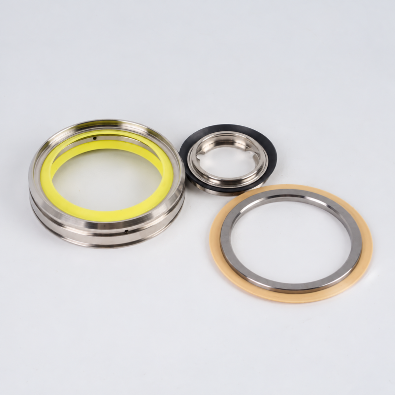 Three assorted vacuum pump shaft seals supplied by IKSONIC: a large yellow-centered ring at left, a smaller black-rimmed seal above center, and a tan-rimmed ring at lower right.