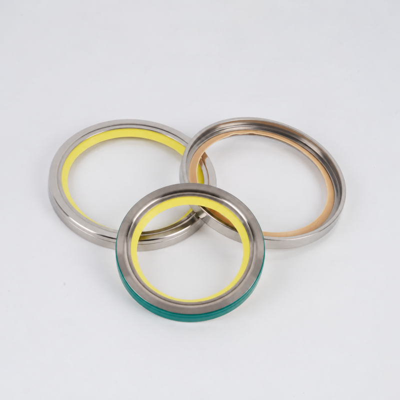 Three overlapping vacuum pump shaft seal rings supplied by IKSONIC, with a yellow inner edge at rear left, a tan inner edge at rear right, and a green outer edge on the front ring.