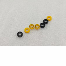 IKSONIC supplier photograph of seven black and yellow plunger seals arranged diagonally, with three black seals and four yellow seals.
