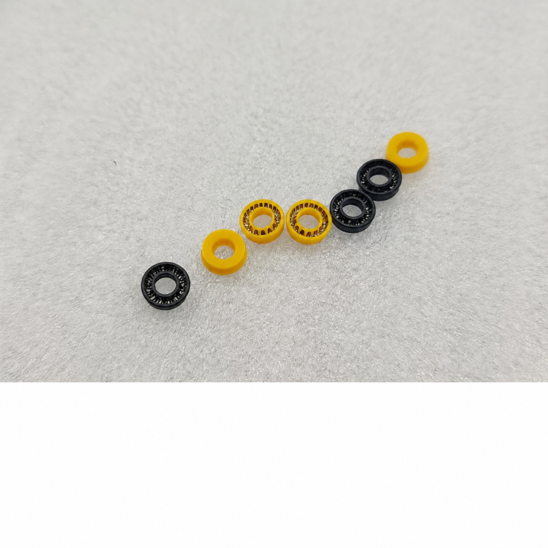 IKSONIC supplier photograph of seven black and yellow plunger seals arranged diagonally, with three black seals and four yellow seals.