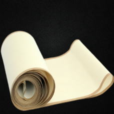Pale unperforated machine belt rolled on a dark background, supplied by IKSONIC.