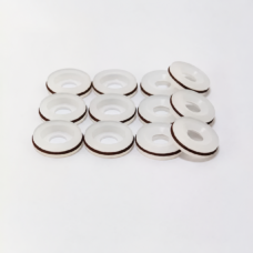 White dispensing valve seals showing recessed faces and reverse sides, IKSONIC product view.