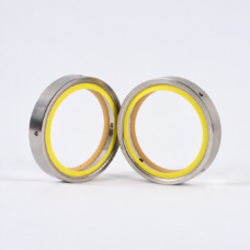 Reverse view of two upright vacuum pump shaft seals with yellow rings, available from IKSONIC in China
