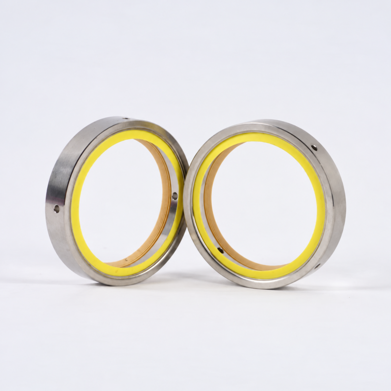 Reverse view of two upright vacuum pump shaft seals with yellow rings, available from IKSONIC in China