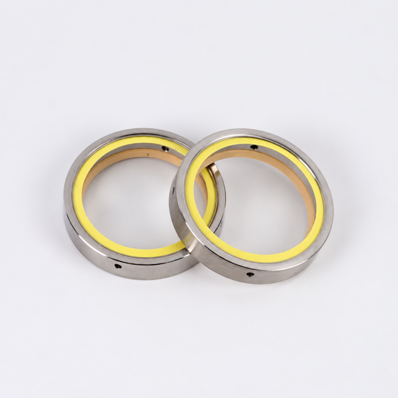 Overlapping vacuum pump shaft seals showing yellow sealing rings and metal housings, IKSONIC supplier