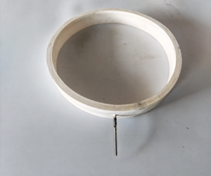 Angled view of a white IKSONIC annular inflatable silicone ring with one extended metal air inlet.
