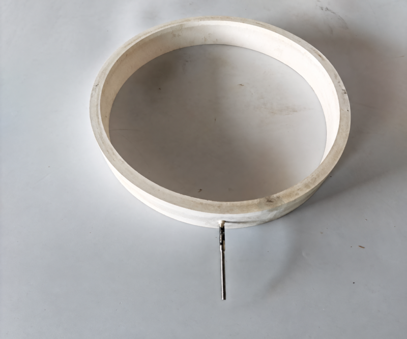 Angled view of a white IKSONIC annular inflatable silicone ring with one extended metal air inlet.