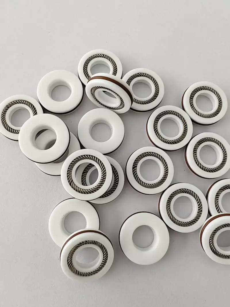 White rotary seals with canted spring channels and dark outer bands, IKSONIC product detail.