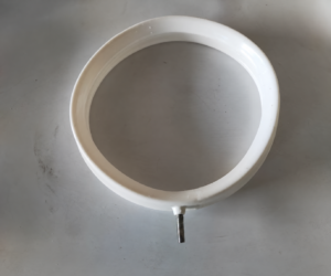 Top view of a white IKSONIC annular silicone bag-clamping ring with one metal air inlet on a gray surface.