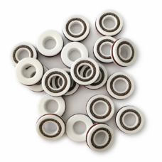 White spring-energized seal assortment showing lips, bores and reverse faces, available wholesale from IKSONIC.