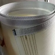 White IKSONIC woven mesh conveyor belt roll with reinforced edge, manufactured in China.
