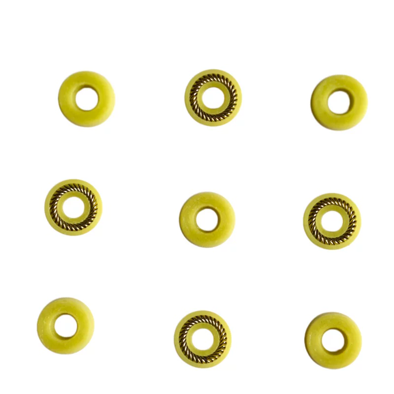 Nine yellow dispensing seals arranged to show spring-loaded and reverse faces, available from IKSONIC.