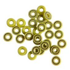 Yellow spring-energized dispensing valve seals showing spring channels and reverse faces, IKSONIC China supplier.